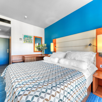 Hotel room with a double bed and a blue wall