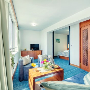 Living area with a sofa and view towards the bedroom