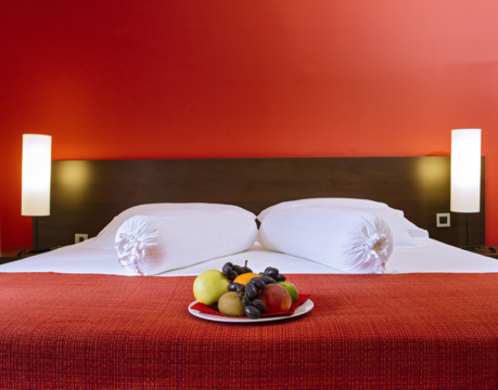 hotel room with double bed in red tones