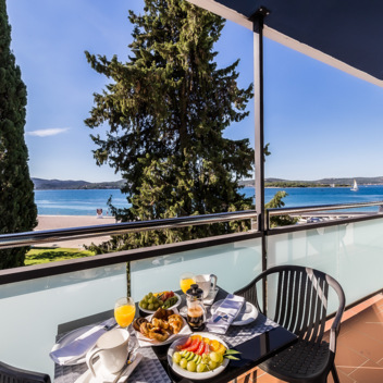 Balcony table set for breakfast with sea view